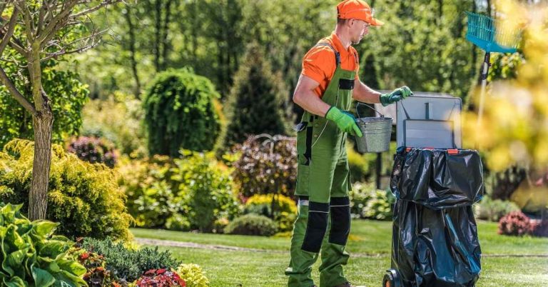 A gardener cleaning private yard area after routine maintenance